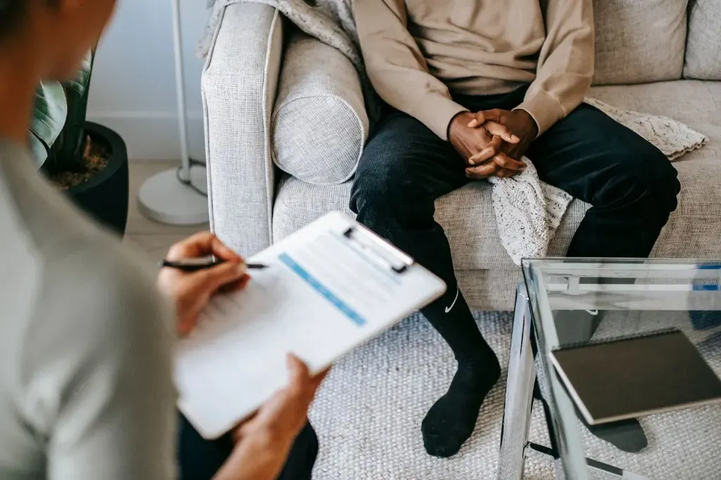 Provider taking notes during a supportive psychiatric consultation